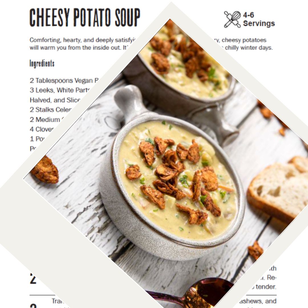 A creamy bowl of cheesy potato soup topped with crispy garnishes, served in a rustic ceramic bowl alongside a slice of crusty bread on a wooden table.