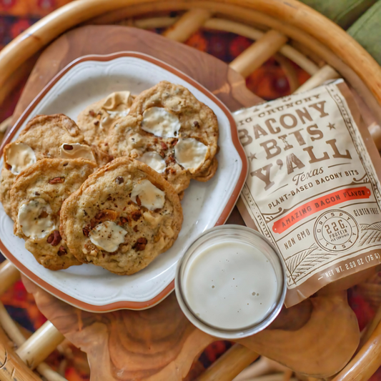 A plate of vegan cookies with marshmallow and bacon bits, served with a glass of plant-based milk, using products from https://allyallsfoods.com/.