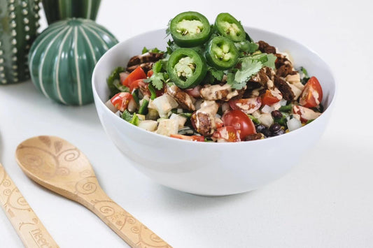 Colorful plant-based salad bowl with fresh vegetables, black beans, jalapeños, and plant-based protein, perfect for a healthy plant-based diet.