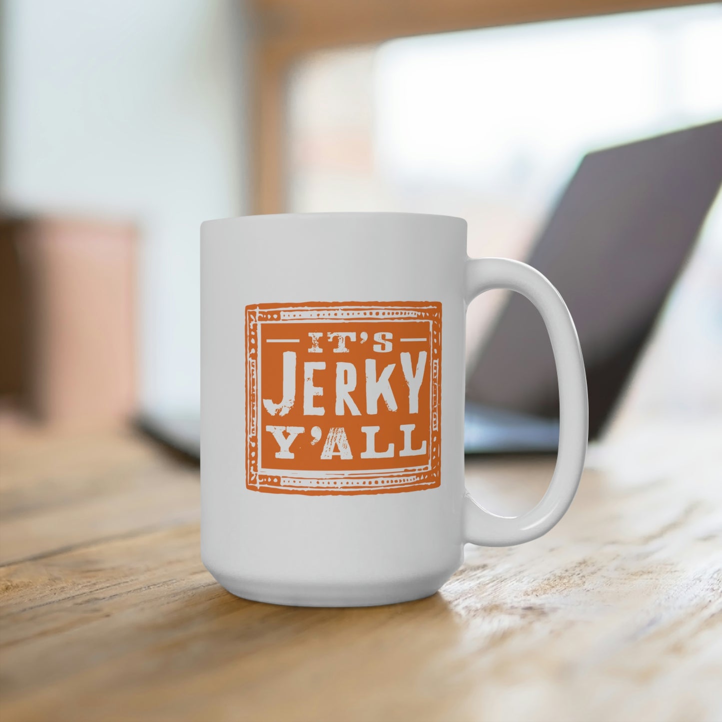 White ceramic coffee mug featuring a bold orange design with the phrase 'It's Jerky Y'All,' perfect for enjoying hot beverages in style.